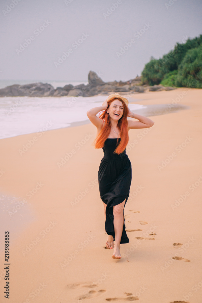happy woman running along beach, summer evening happy woman running along beach, summer evening