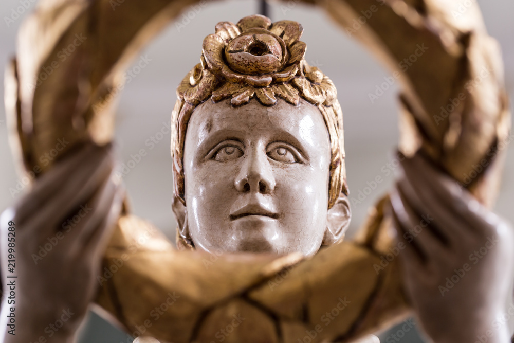 Face of an old angel with golden ornaments Face of an old angel with golden ornaments