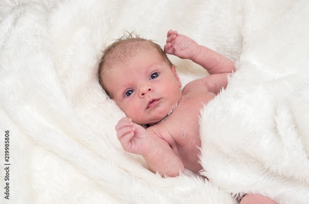 newborn baby girl on white fluffy coverlet with the inscription baby newborn baby girl on white fluffy coverlet with the inscription baby