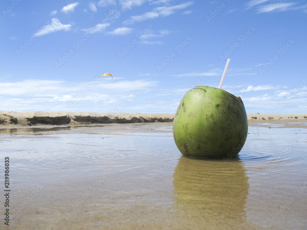 Green coconut on beach and sea with blue sky - vacations Green coconut on beach and sea with blue sky - vacations
