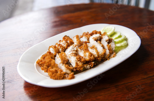 The fried chicken in a dish with cucumber,  eat with rice as foods that are beneficial to the body