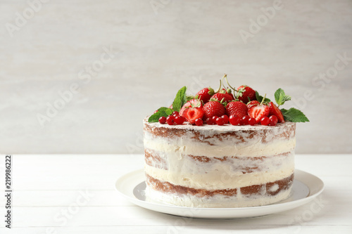 Delicious homemade cake with fresh berries and space for text on wooden table