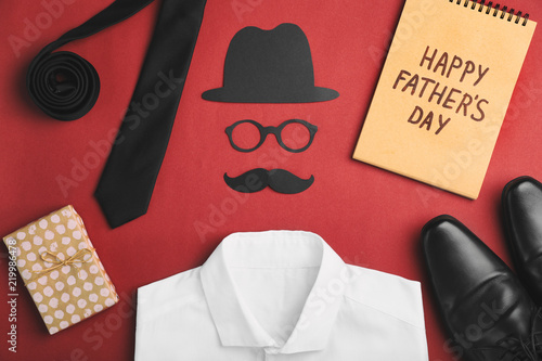Flat lay composition with shirt, shoes and paper decor on color background. Happy Father's Day