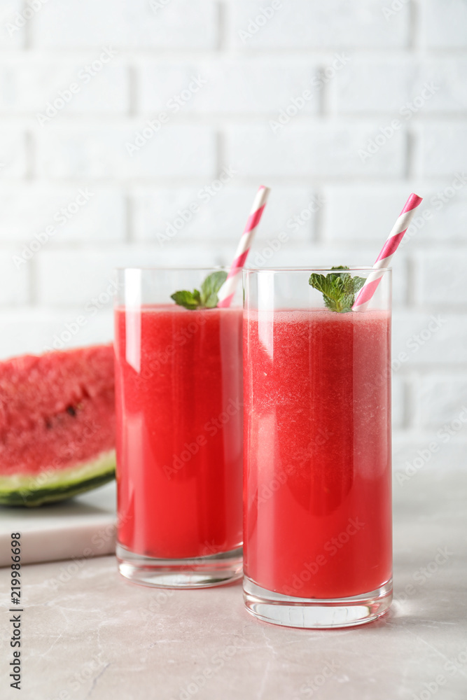 Tasty summer watermelon drink in glasses on table Tasty summer watermelon drink in glasses on table