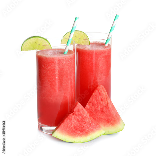 Tasty summer watermelon drink in glasses and slices of fresh fruit on white background