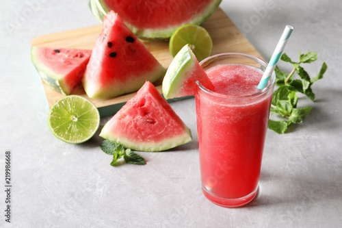 Tasty summer watermelon drink in glass and fresh fruits on table