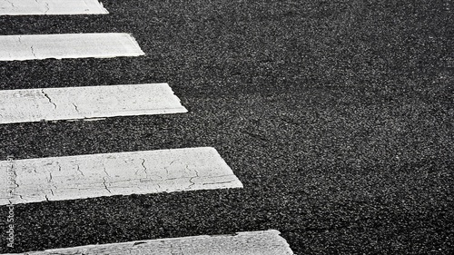 Fotografie, Obraz Zebra crosswalk on a asphalt road - closeup background
