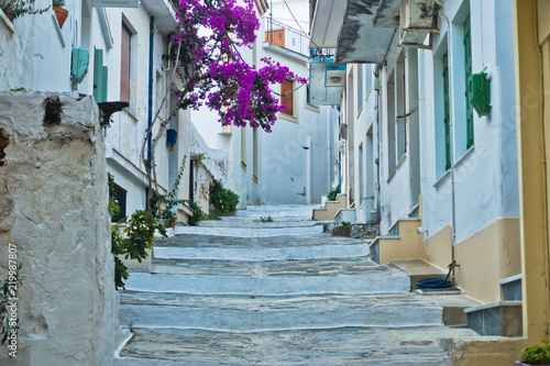 Narrow alleys with traditional greek houses at Skopelos old town, sunset at Skopelos island, Greece