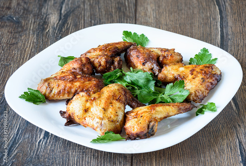 Hot and spicy buffalo chicken wings on white plate