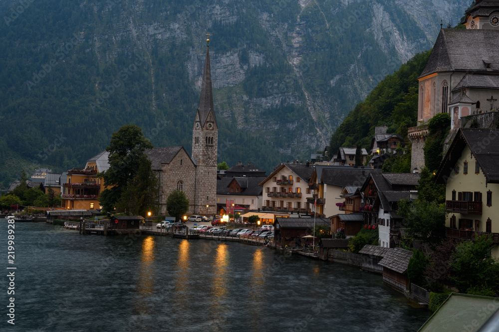 View of the Alpine town of Hallstatt on the shore of a mountain lake at sunset