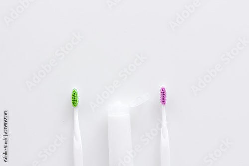 Clean teeth. Toothbrushes and tooth paste on white background top view space for text