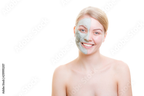 Woman having mud green mask on her face