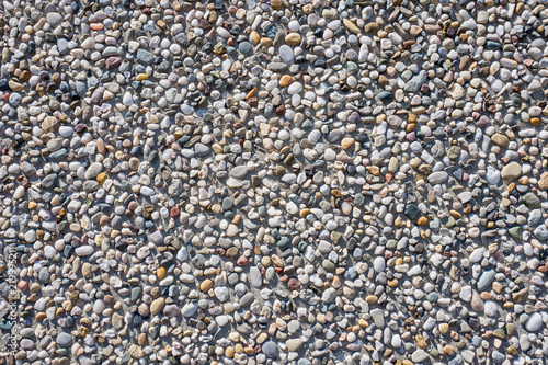 Concrete wall with pebbles.