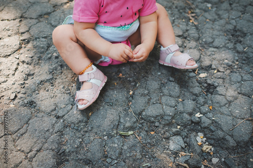 Little girl in pink on ground