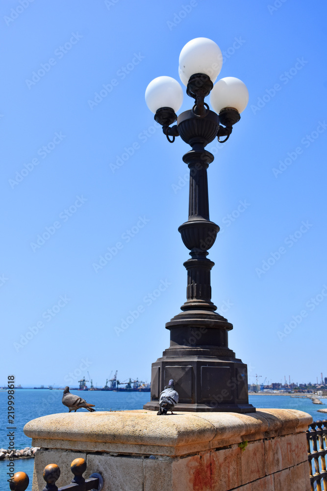 Italy, Puglia region, Taranto, street lamps for street lighting in the city and seafront.