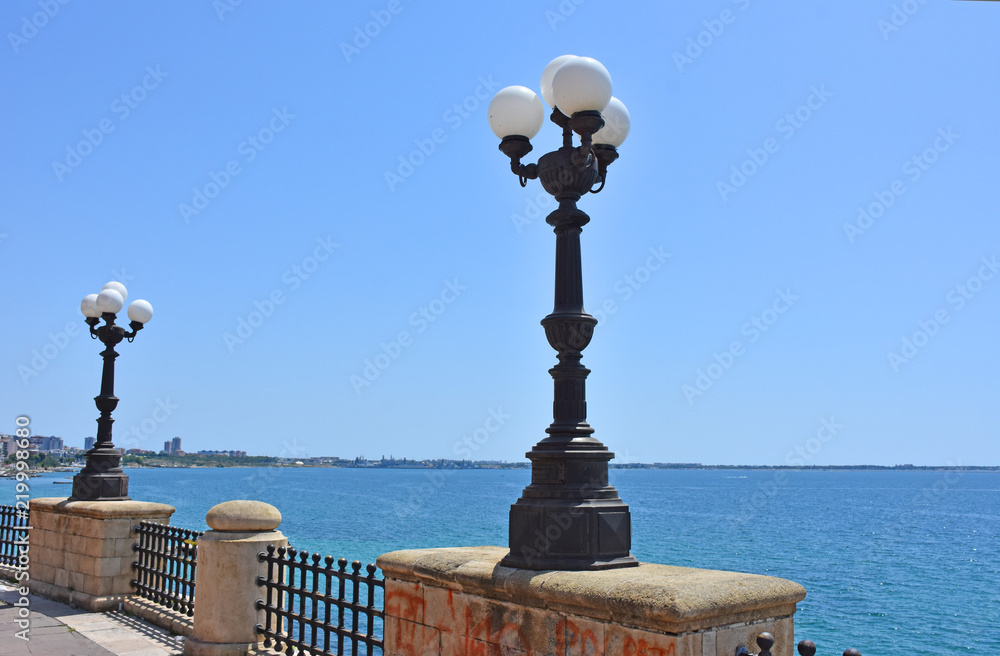 Italy, Puglia region, Taranto, street lamps for street lighting in the city and seafront.