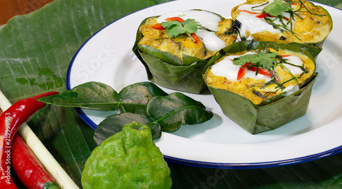 Steamed fish with curry paste (Thai language Hor mok) in banana leaf bowl Thai food