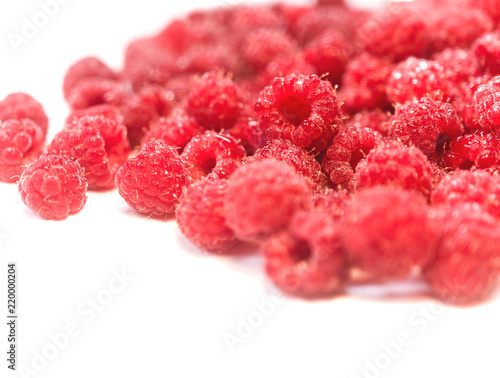 Dripping raspberry on white background.