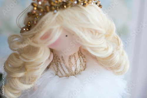Textile doll with beautiful tiara on curly blond hair. Handmade. Doll with white dress