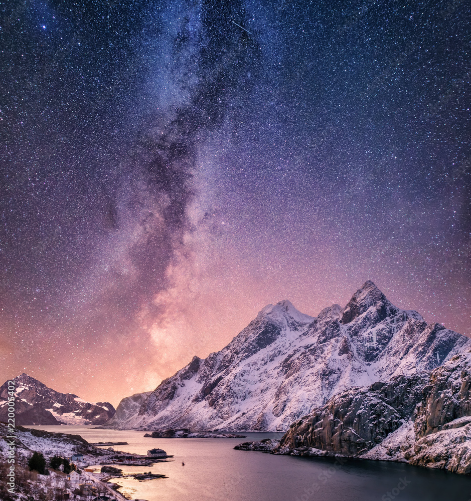 Fototapeta Mountans and reflection on the water surface at the night time. Sea bay and mountains at the night time. Milky way above mountains, Norway. Beautiful natural landscape in the Norway