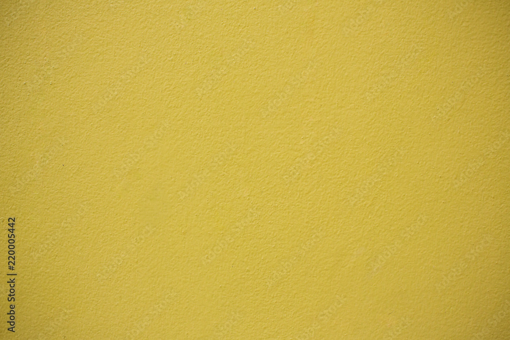 Yellow Concrete Wall Background.Concrete wall yellow color for texture background.Mustard rough concrete wall surface. Yellow Concrete Wall Background.Concrete wall yellow color for texture background.Mustard rough concrete wall surface.