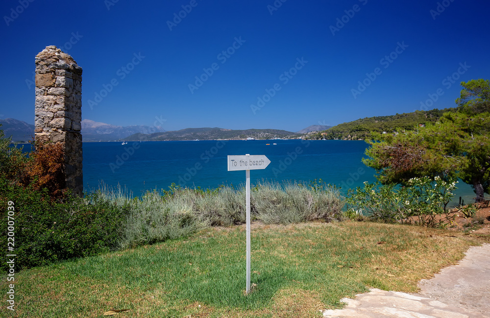 Travel Greece. To the beach sign. Spectacular view on one of the most beautiful beaches in Poros Island. Summer holiday