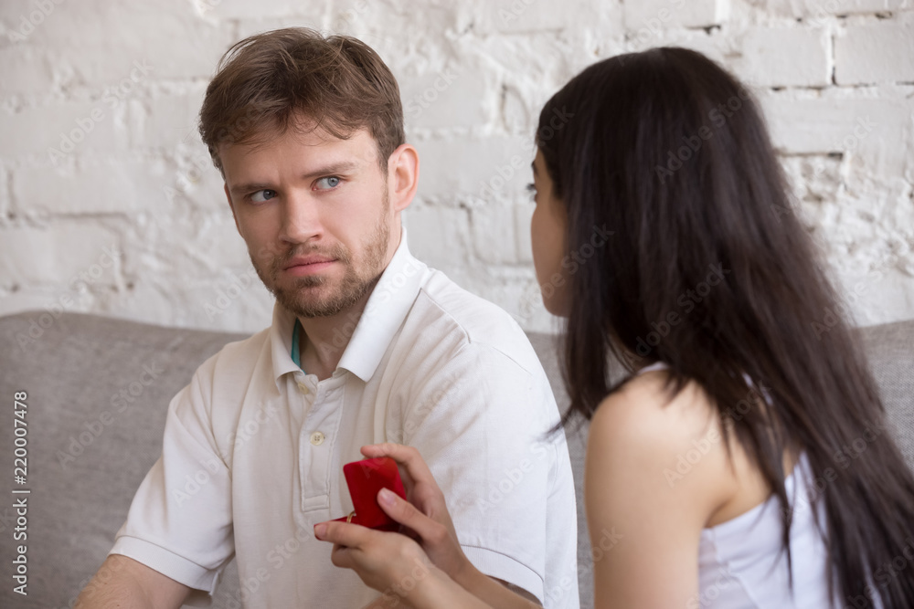 Decisive girlfriend making marriage proposal to frustrated boyfriend ...