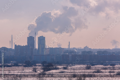 Winter landscape industrial outskirts of the city. Silhouettes of buildings and cranes. © frolova_elena