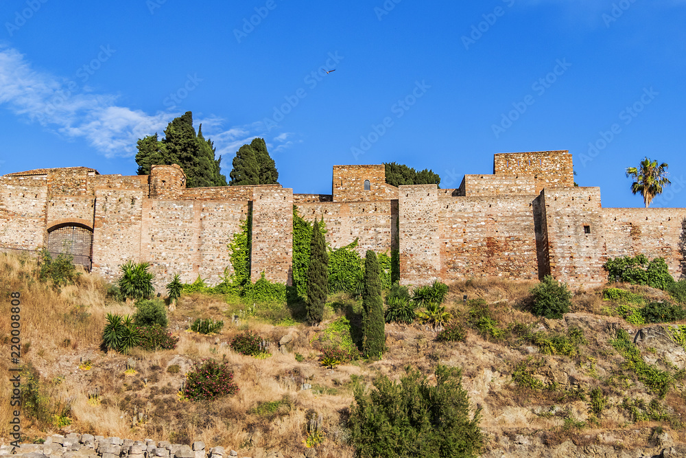 External view of Alcazaba Walls - palatial fortress in Malaga built in XI century. Fortress palace, whose name in Arabic means citadel, is one of city's historical monuments. Malaga, Andalusia, Spain.