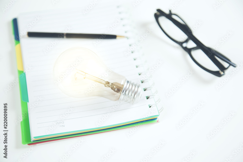 Idea or light bulb on notepad Idea or light bulb on notepad