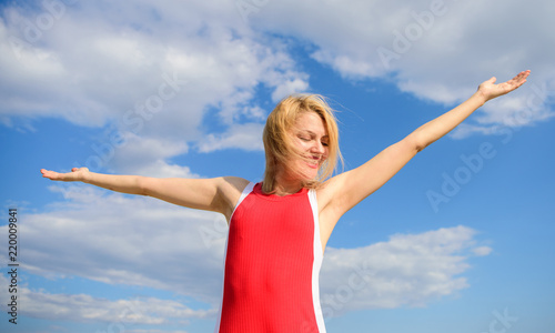 Girl pleased with freedom looks relaxed carefree blue sky background. Feel harmony and peace. Take it easy. Woman blonde relaxing outdoors. Take minute care about your wellbeing and harmony © be free