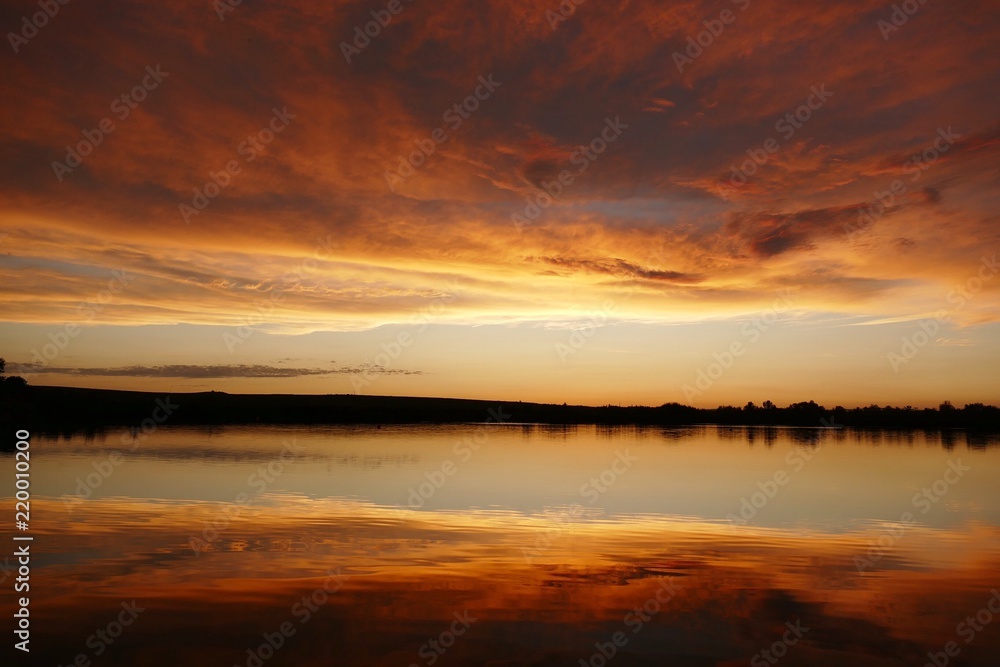 dawning sun mirroring in the lake