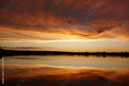 dawning sun mirroring in the lake