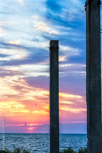 Ferroconcrete pillars against a background of a scenic sunset, close-up
