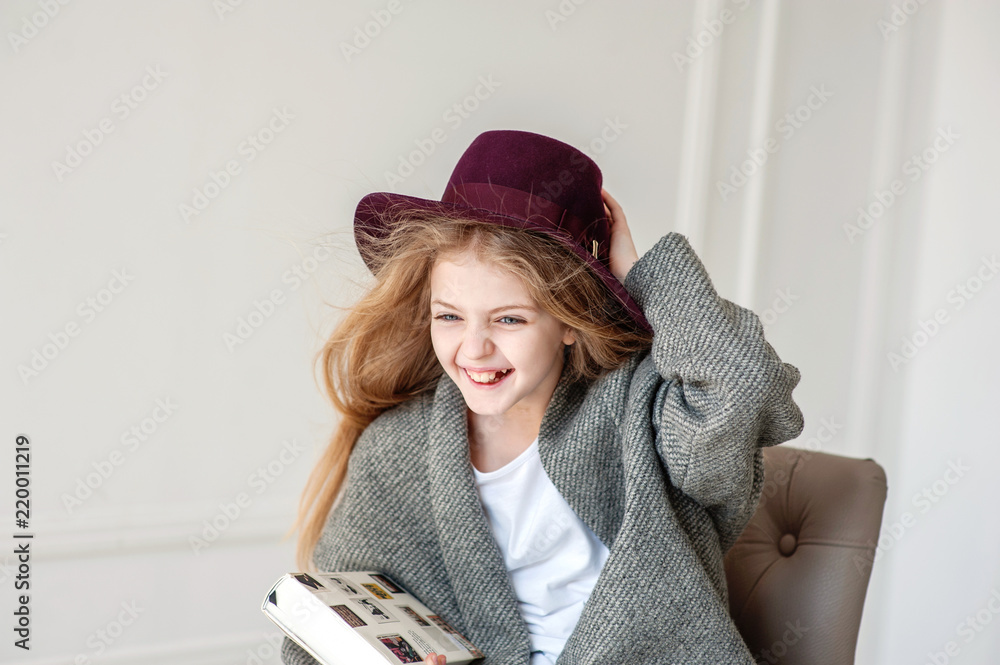 © Olena - The beautiful smiling girl with a fair hair indoors with an interior © Olena - The beautiful smiling girl with a fair hair indoors with an interior