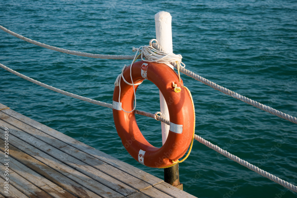 Life buoy hanging at the end of the pier