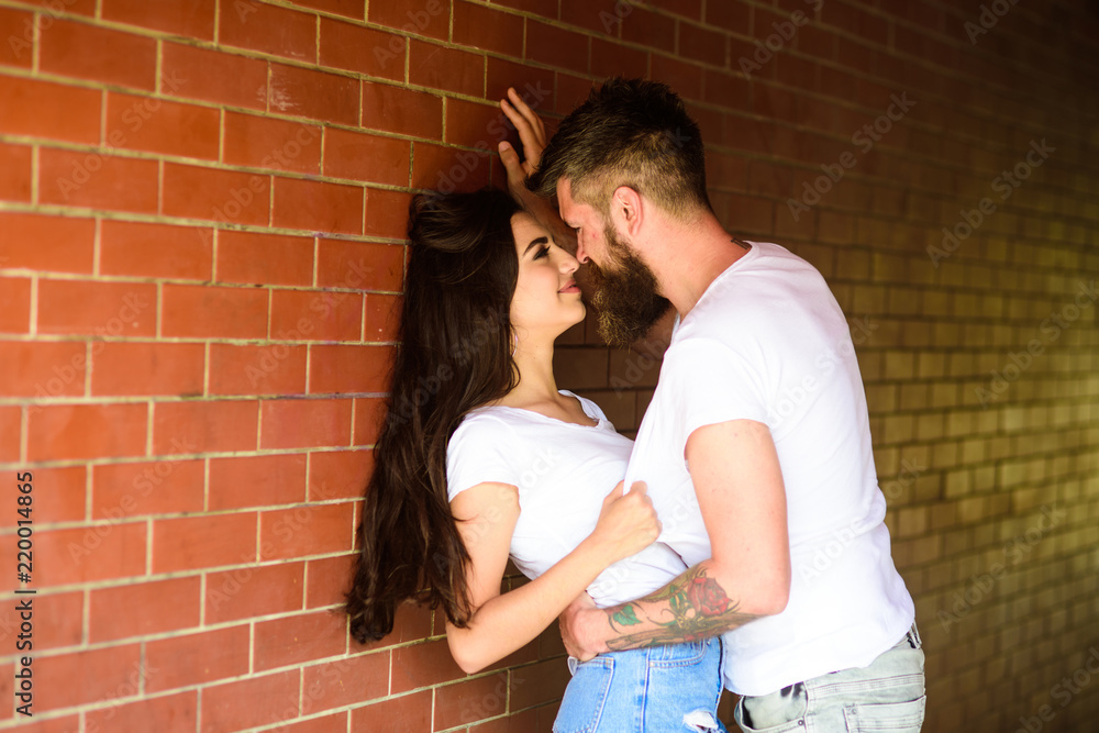 No rules for them. Couple enjoy intimacy without witnesses public place. Girl and hipster full of desire cuddling. Couple in love full of desire brick wall background. Couple find place to be alone