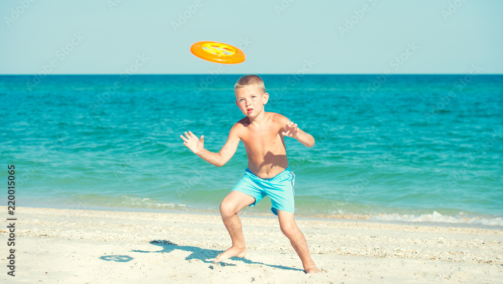 A child is playing with a frisbee on the beach. A child is playing with a frisbee on the beach.