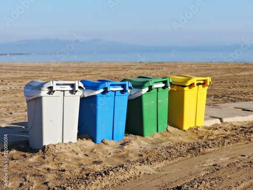 Cuatro contenedores por tipo de basura en la playa photo