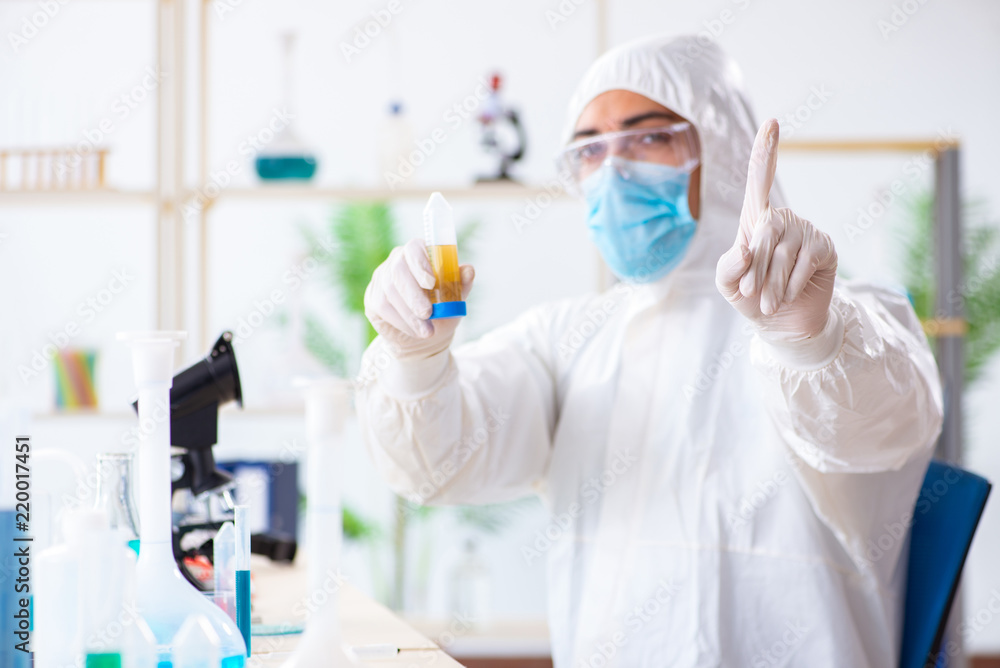 Young chemist student working in lab on chemicals Young chemist student working in lab on chemicals