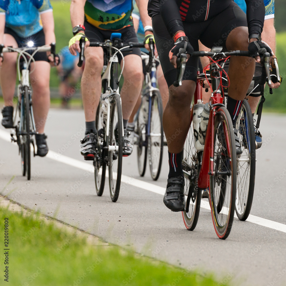 Fototapeta premium Group of cyclists competing in a race cropped square with a shallow depth of field and copy space