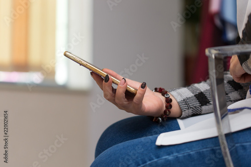 woman sitting with smartphone