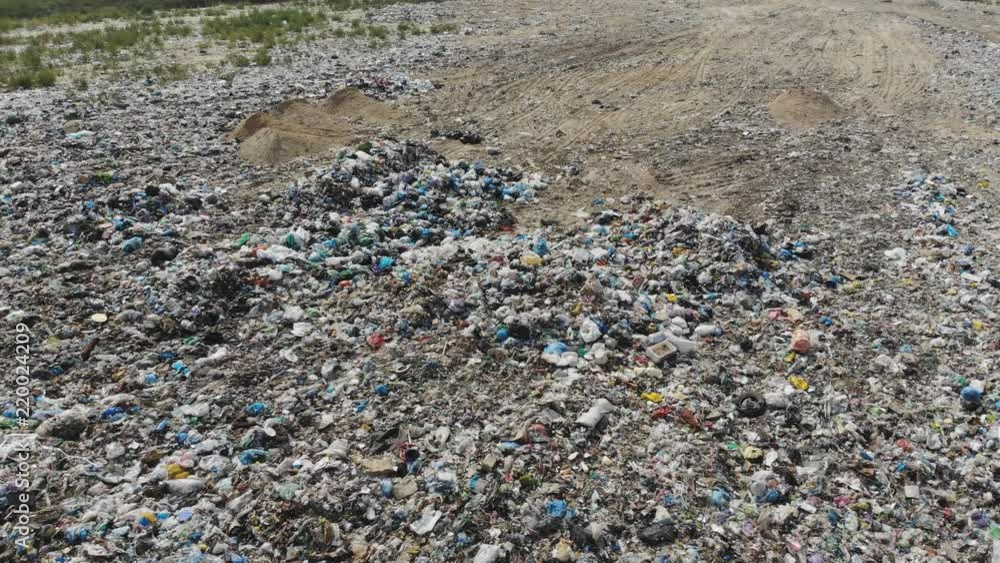 Garbage dump from above Aerial. Directly above. Landfill garbage dump and tractor working. Garbage dump from above Aerial. Directly above. Landfill garbage dump and tractor working.