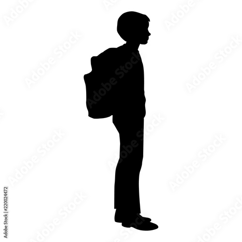Isolated silhouette of a boy standing with a backpack 