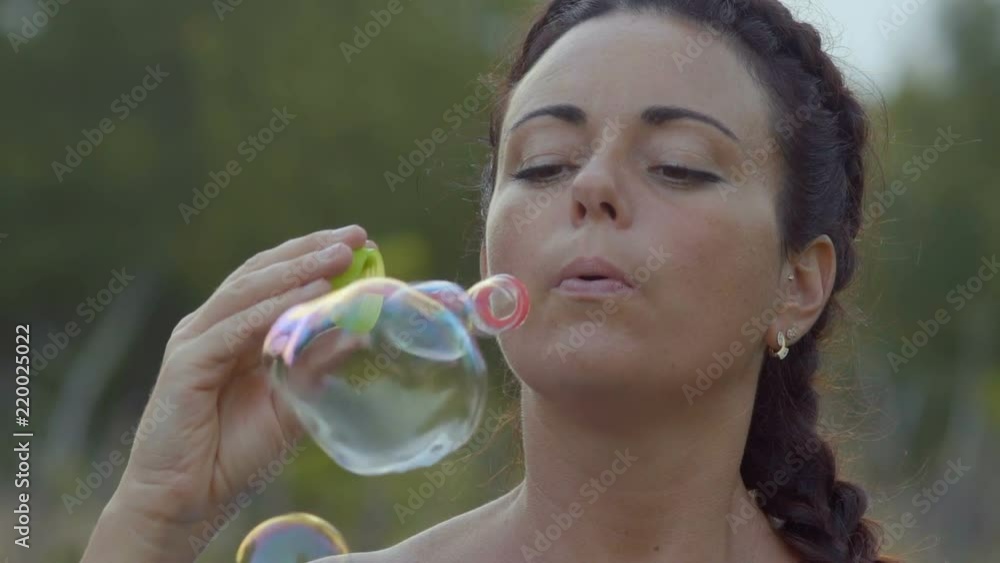 Slow Motion, Beautiful Woman with Coins Runs Soap Bubbles In the Evening Slow Motion, Beautiful Woman with Coins Runs Soap Bubbles In the Evening