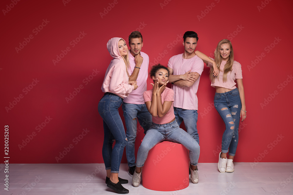 Group of young people posing in pink clothes. Group of young people posing in pink clothes.