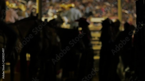 Late night at the local summer rodeo performers waiting to go out in the arena.