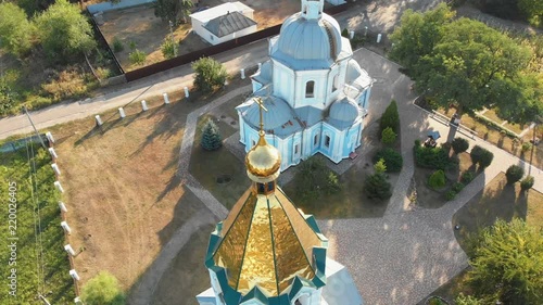 Aerial view of the Ukrainian Christian Church Located in the Village. View from the drone on the church, domes and cross. Summer, sunny day. photo