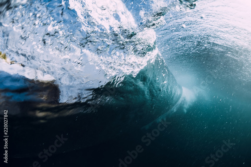 Underwater barrel wave crashing in ocean.