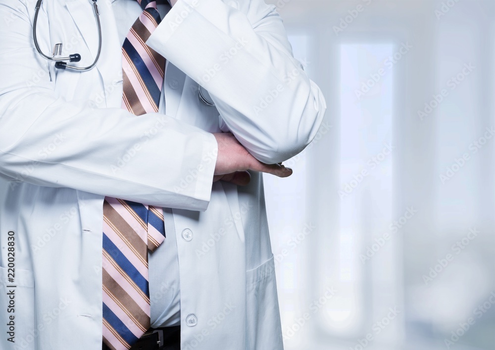 Male doctor with stethoscope on blurred hospital background Male doctor with stethoscope on blurred hospital background